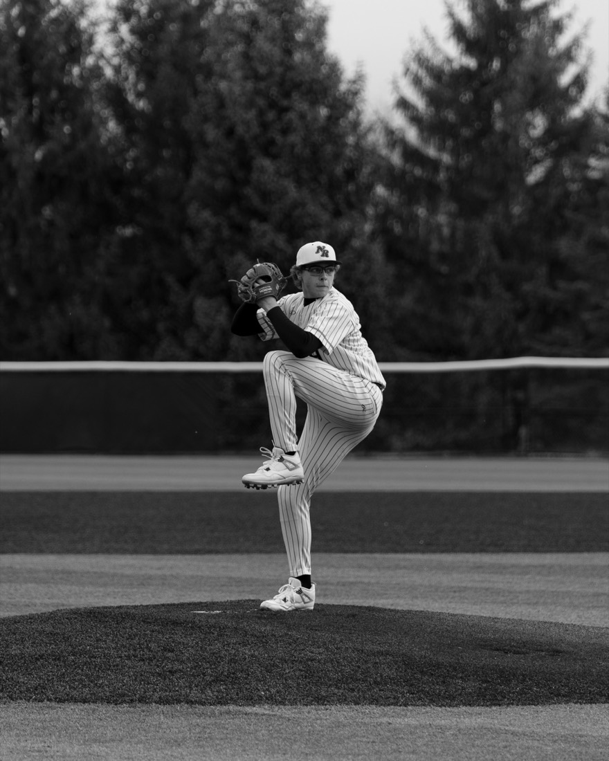 Baseball pitcher mid-windup in black and white